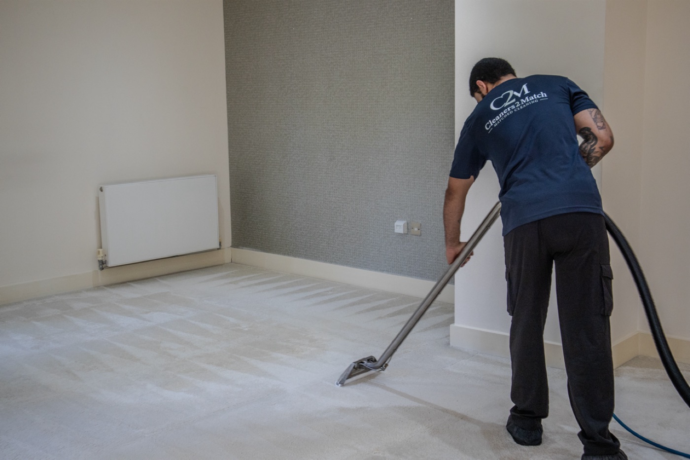 Cleaners2Match technician using hot water extraction wand on carpet
